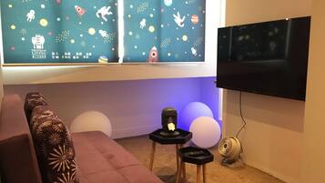 Relax in this inviting living room with a comfortable sofa, side table, and mounted TV.