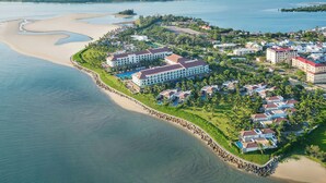 A coastal resort with beachfront villas, a central hotel, and a marina. - Renaissance Danang Hoi An Resort & Spa (Da Nang)