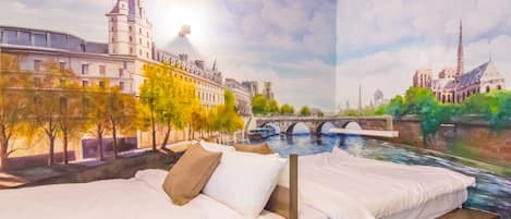 A bedroom with a mural of a cityscape, a bed, and a nightstand.