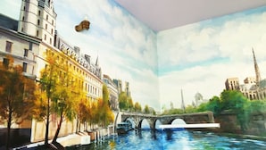 A room with a mural of a cityscape, including a bridge and buildings. - Kaohsiung Rouen (Kaohsiung)