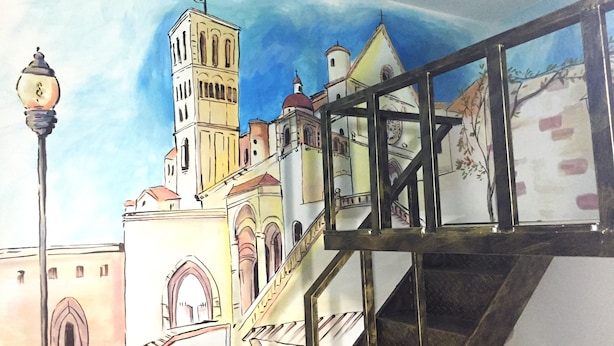 A mural of a cityscape with a prominent tower, a staircase, and a street lamp. - Kaohsiung Rouen (Kaohsiung)