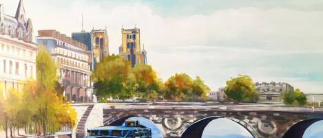 A river with a boat, a bridge, and buildings including a prominent tower.