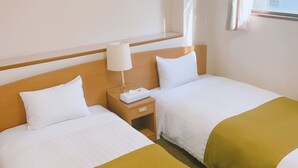 A hotel room with two beds, a nightstand, a lamp, and a window with curtains. - Urban Hotel Tokyo Fuchu-Higashiguchi (Fuchu)