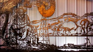 A mural with a man, animals, and a sun. - Matilda Motel (Winton)