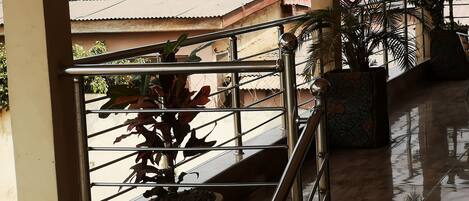 A staircase with metal railings and potted plants.