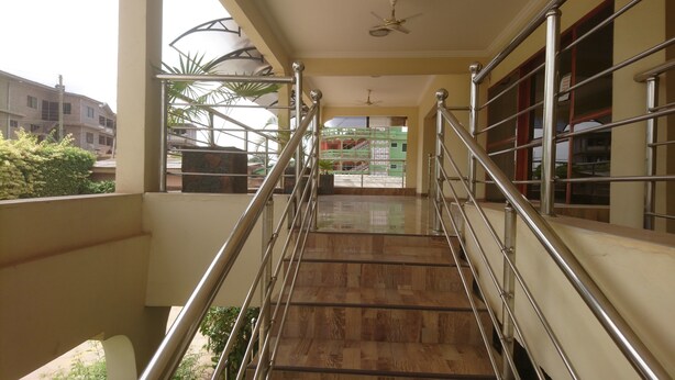 A staircase with metal railings leading to a balcony.