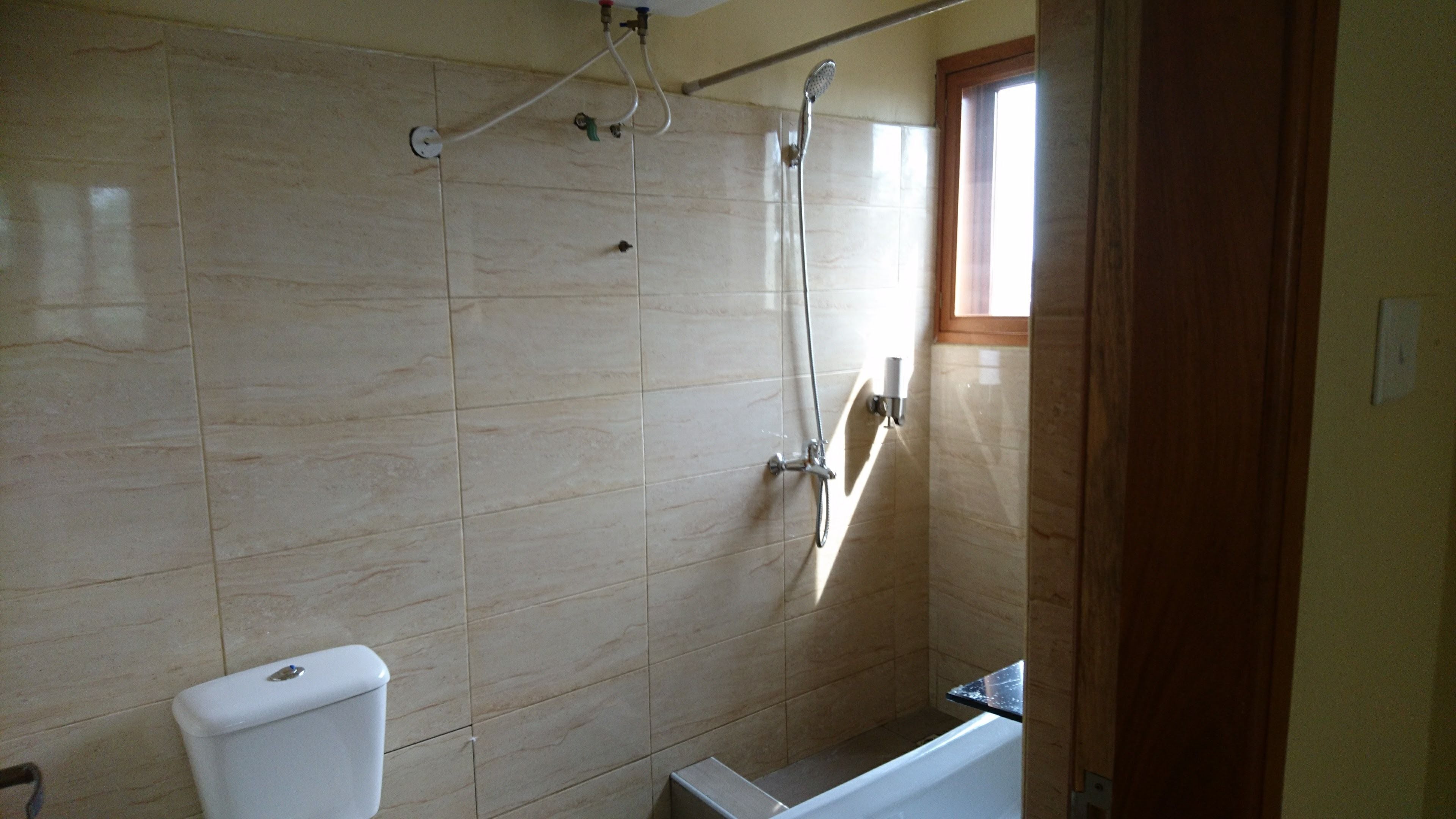 A bathroom with a toilet, a shower, and a bathtub.