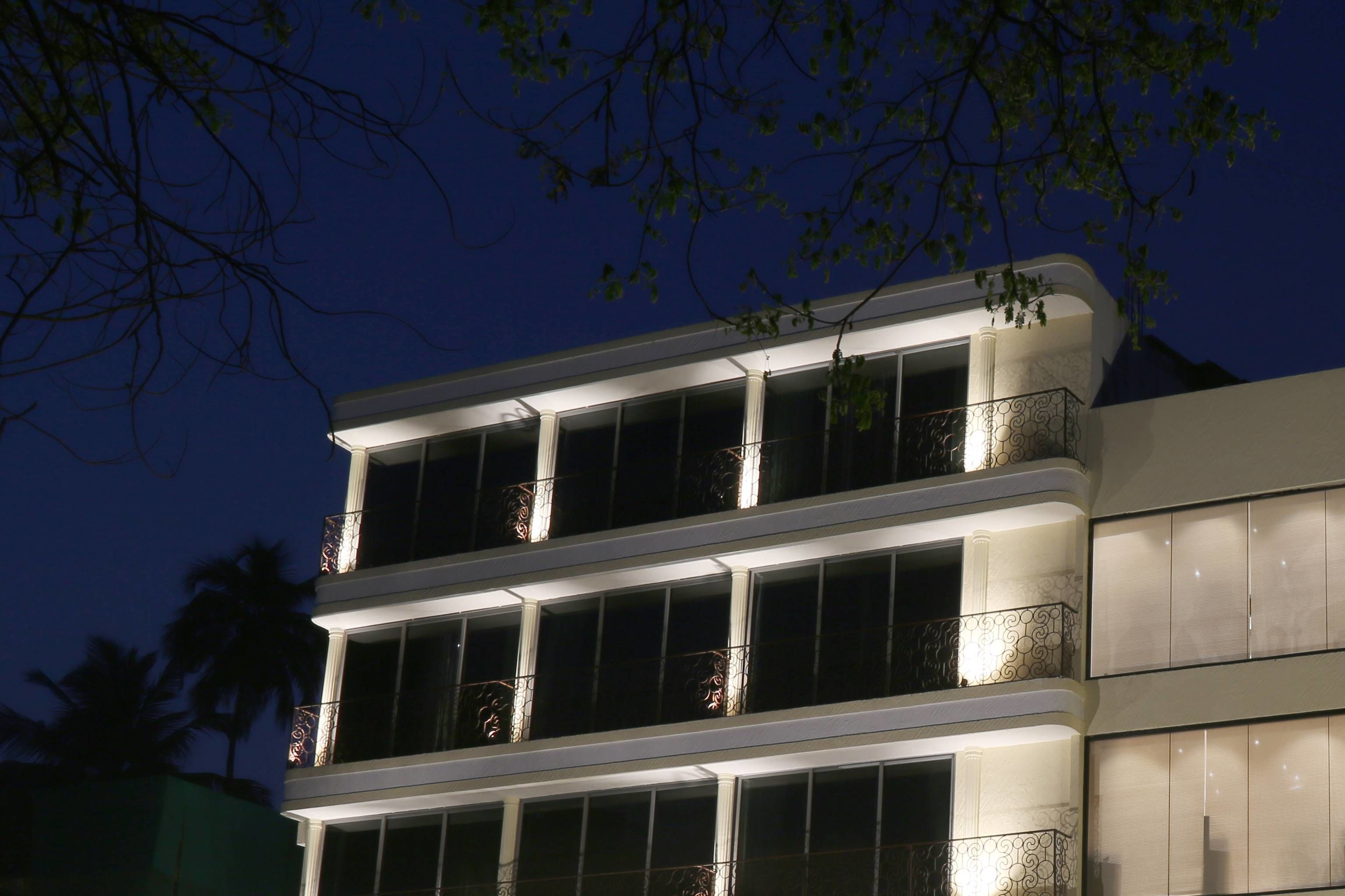 A multi-story building with balconies and large windows, likely a hotel or residential building.