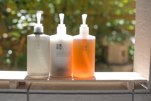 Three bottles of HOKUROKU SOUSUI skincare products on a ledge.