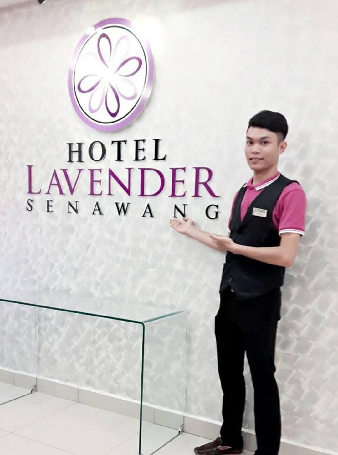A hotel sign with a logo and the name 'HOTEL LAVENDER SENAWANG'.