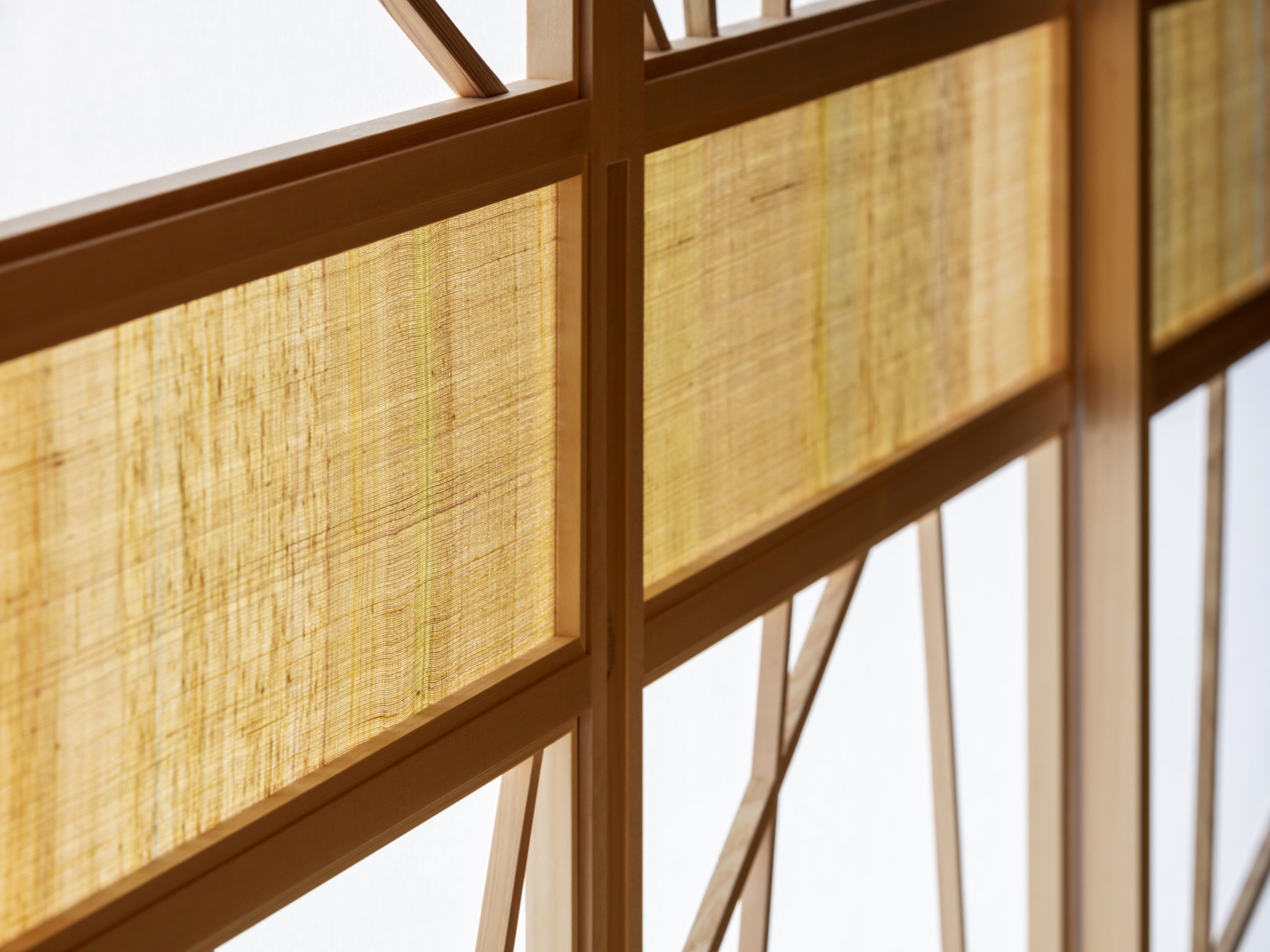 A close-up of a bamboo screen with a wooden frame.