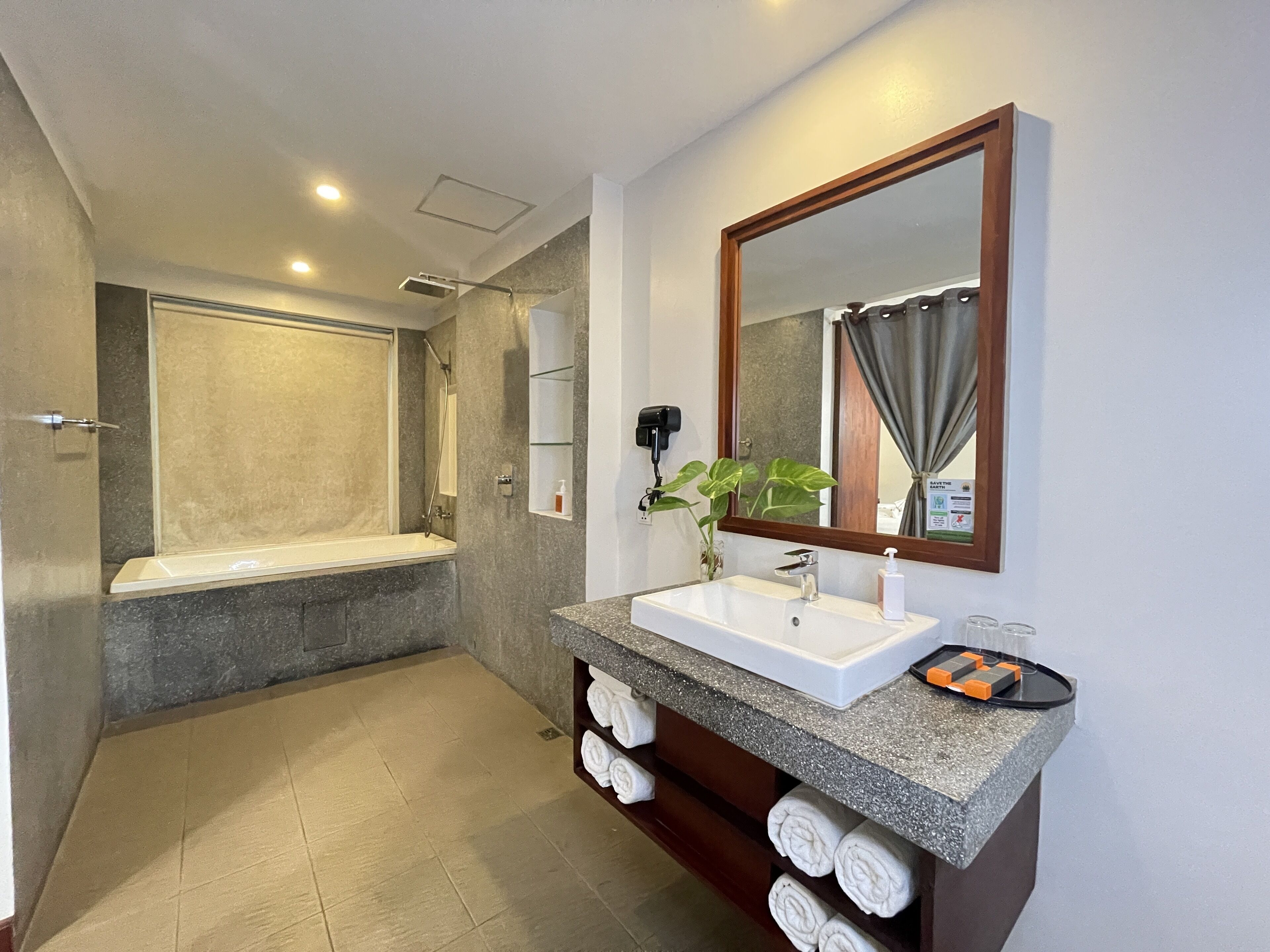 honeymoon suite with balcony pool view | bathroom | designer toiletries, hair dryer, bathrobes, slippers