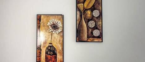 Two wall-mounted artworks with abstract designs.