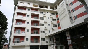 A multi-story building with balconies and air conditioning units. - Hotel Samana (Hetauda)