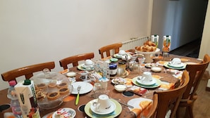A dining table set for breakfast with various food items, plates, and utensils. - Bed and Breakfast Al Cucherle (Trieste)