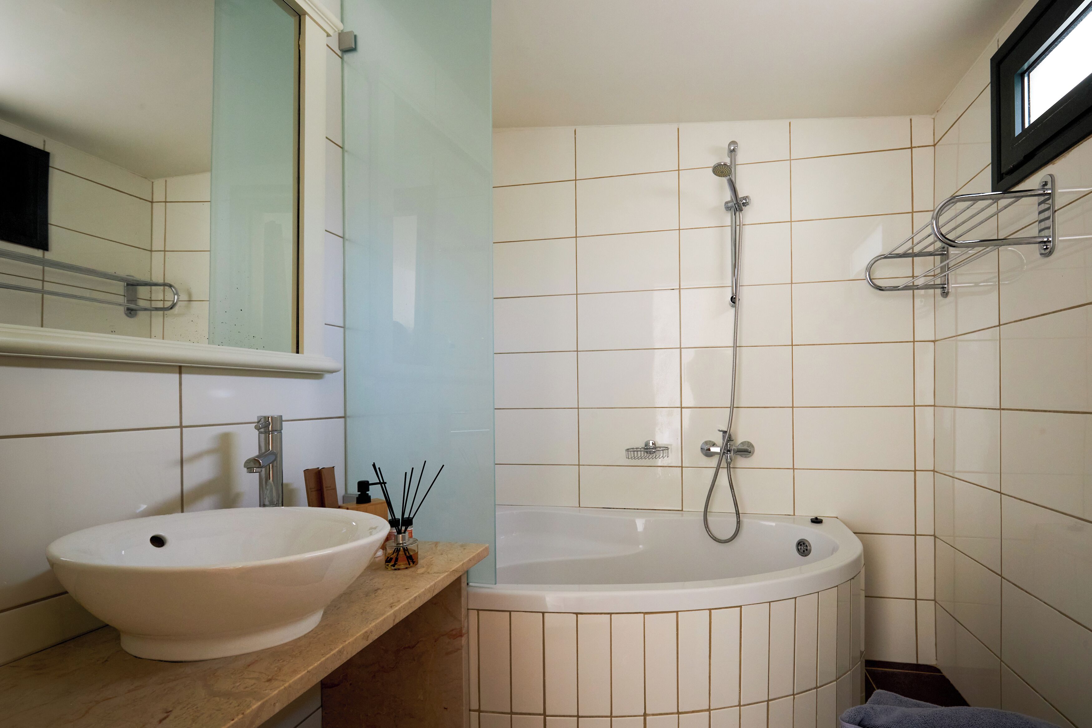 A bathroom with two sinks, a bathtub, and a shower.