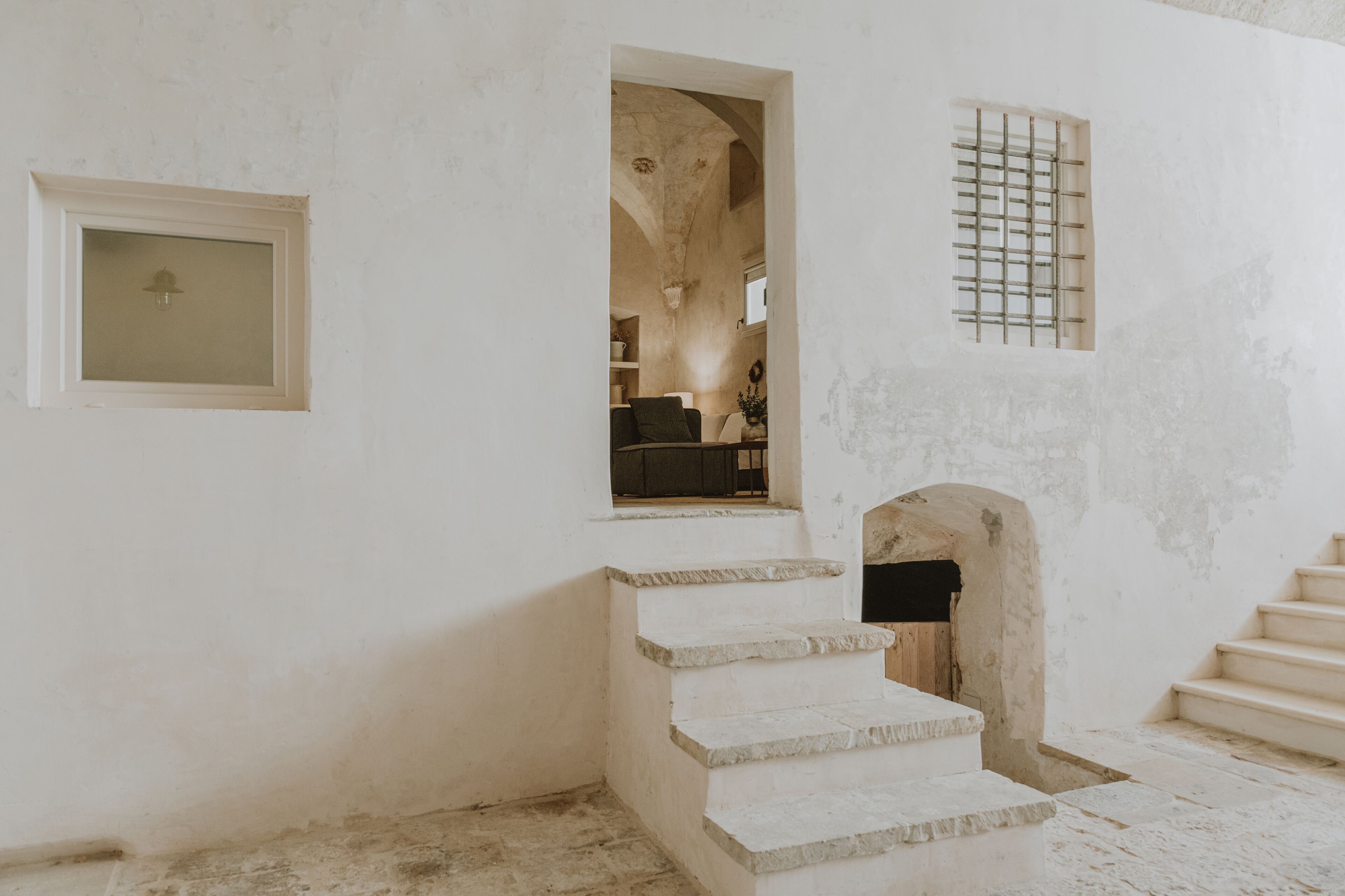 A staircase leading to a room with a window and a door.