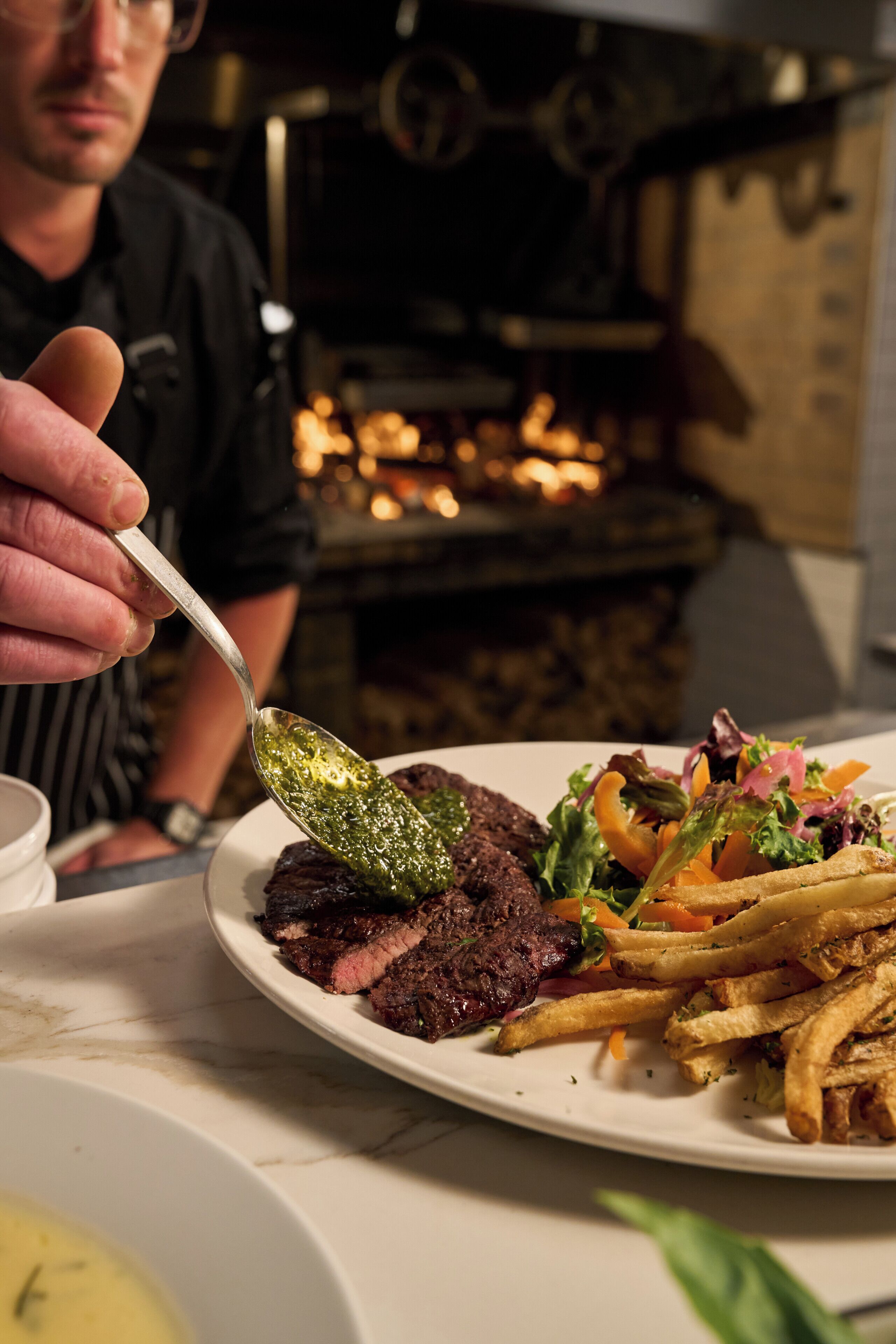 A plate of food with steak, fries, and a salad.