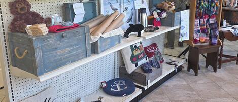 A retail store with shelves displaying various items including plush toys, pillows, and decorative objects.