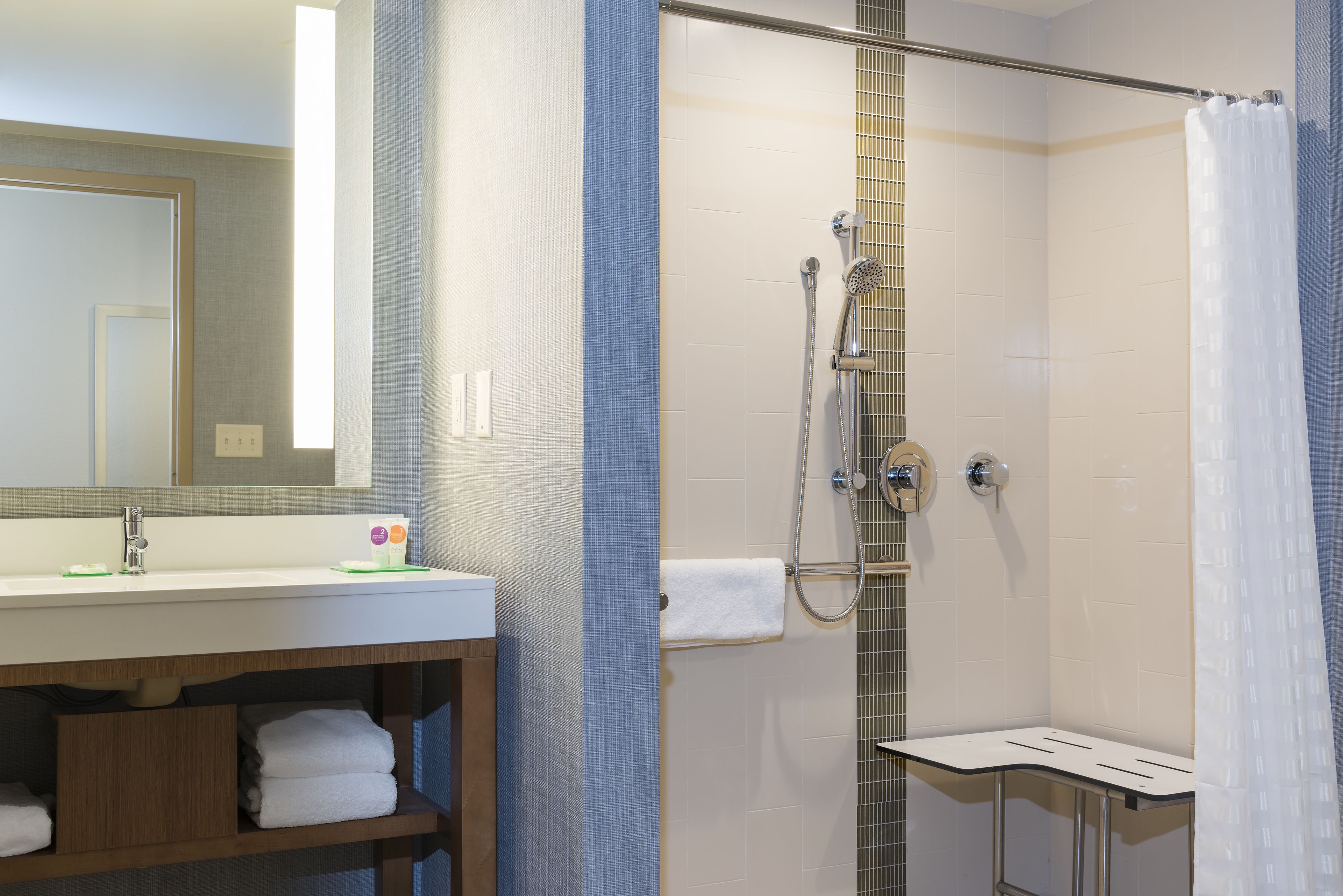 designer toiletries, hair dryer, towels