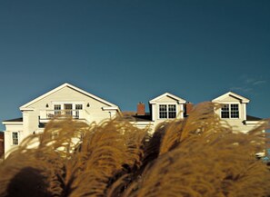 A large white building with a symmetrical facade, multiple windows, and a central entrance. - The Inn at Stonington (Stonington)