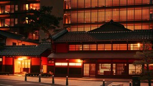 A traditional Japanese building with multiple floors, large windows, and a tiled roof. - Hoshino Resorts KAI Kaga (Kaga)