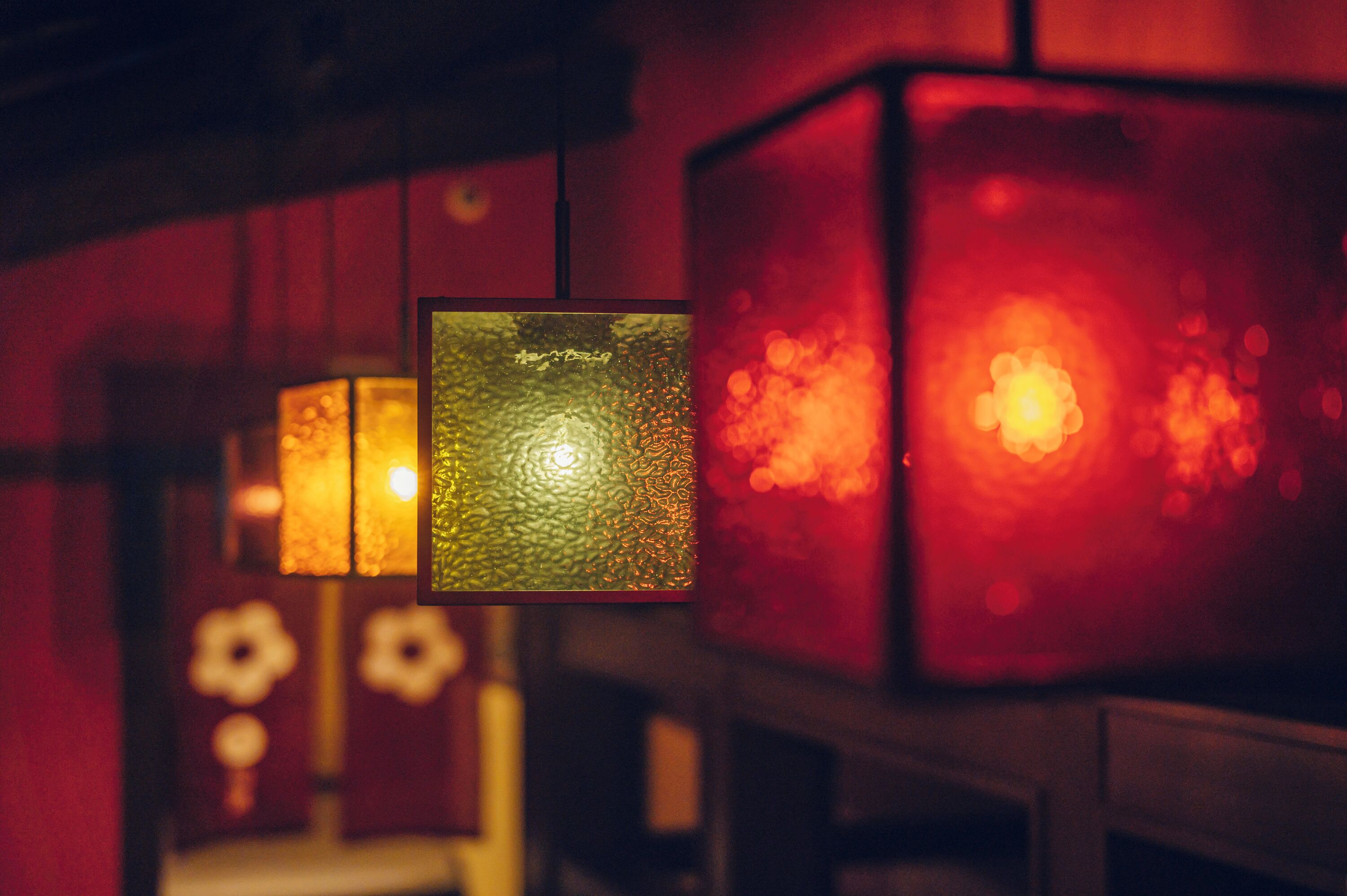 A close-up of a textured glass cube with a warm glow, part of a larger structure with similar elements.