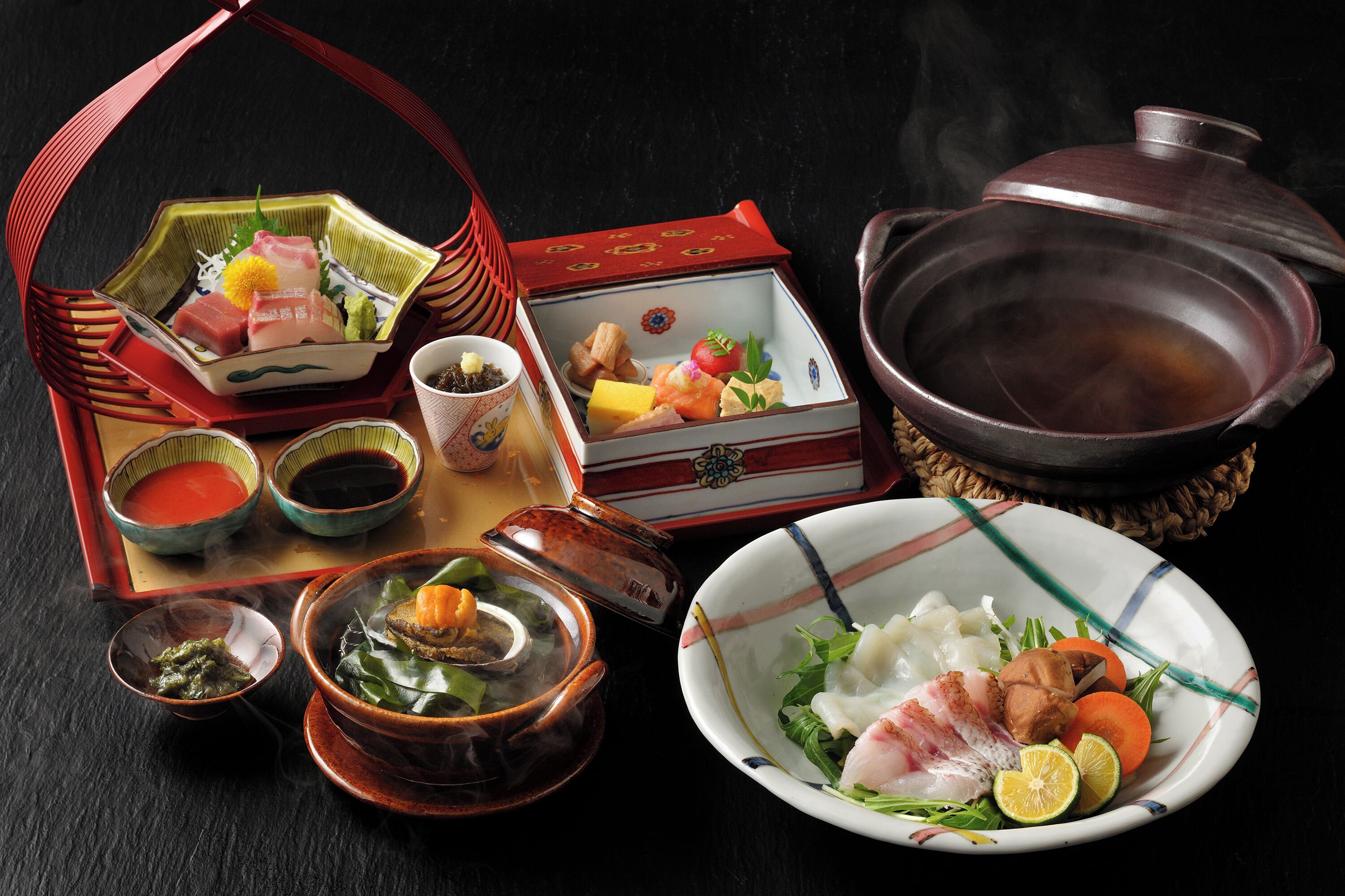 A traditional Japanese meal setup with various dishes and utensils.