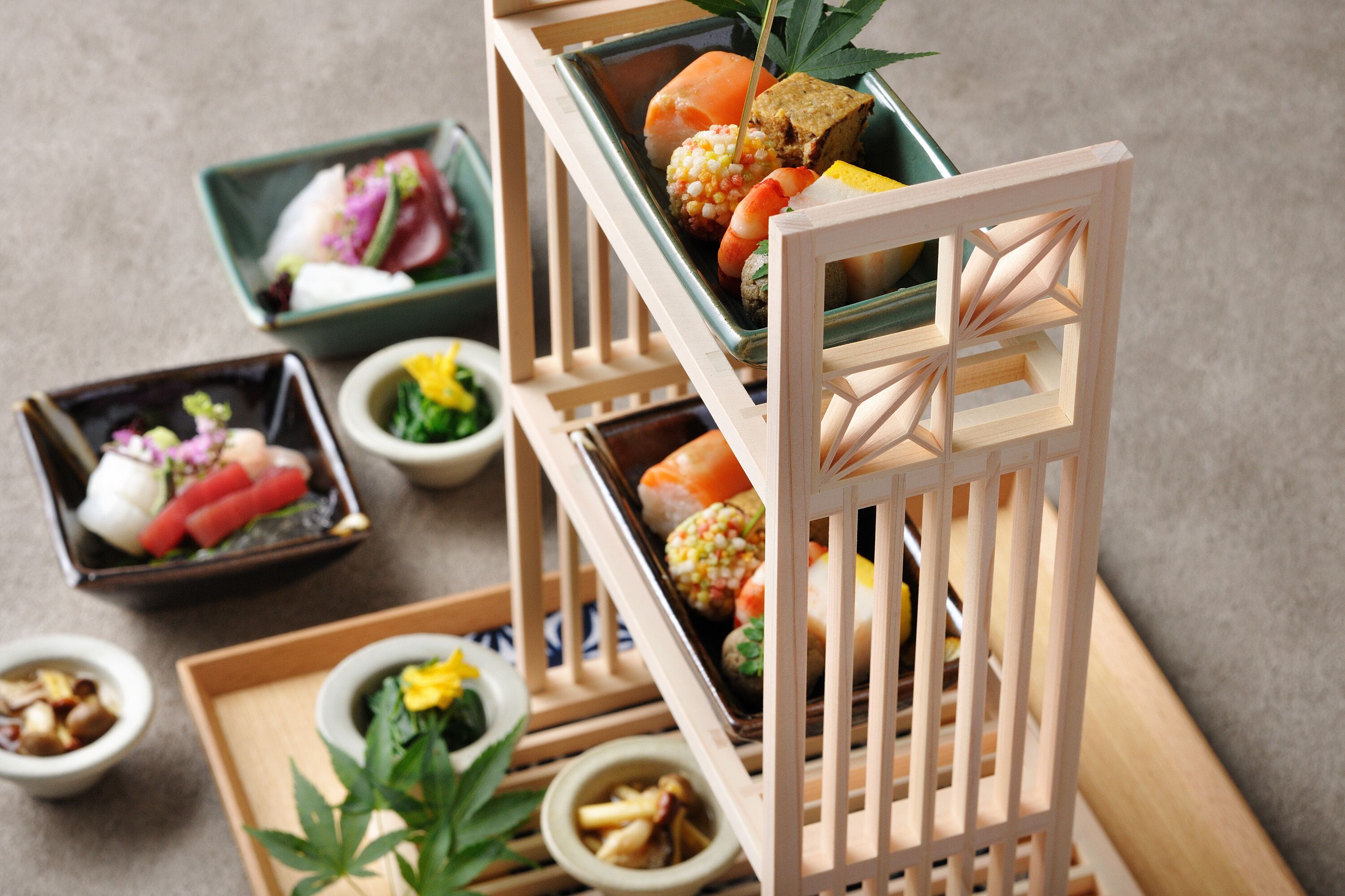 A traditional Japanese tea ceremony setup with a wooden tea tray, a ceramic tea bowl, and a small dish with pickled vegetables.