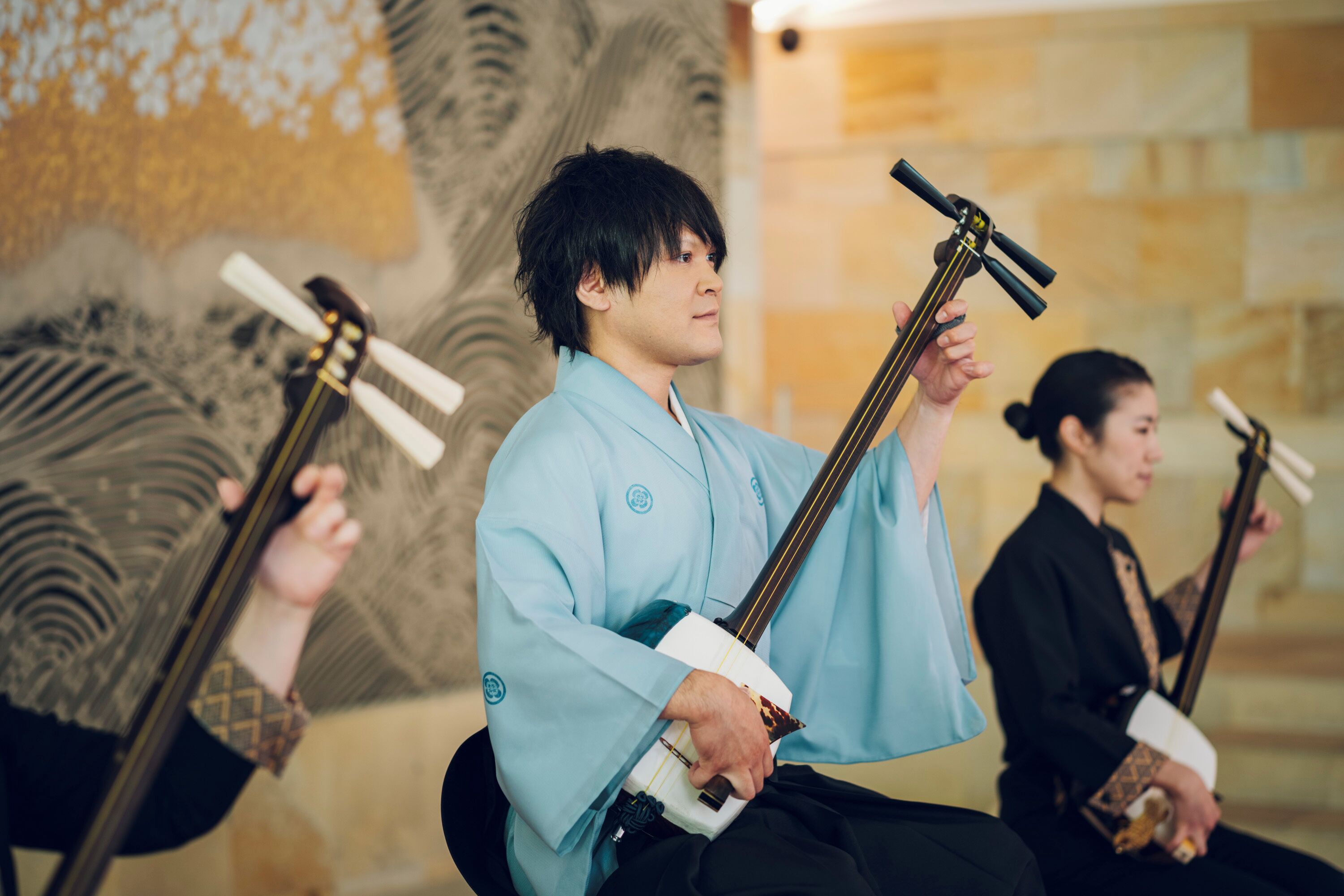 A person playing a traditional stringed instrument.