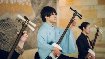 A person playing a traditional stringed instrument.