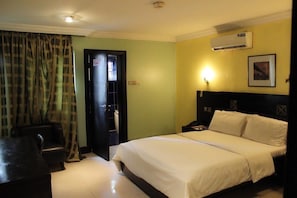 Desk, laptop workspace, bed sheets - The Hedge Suites (Lagos)