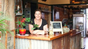 A bar counter with a sign that reads "Please order Meals at the bar, thank you."
