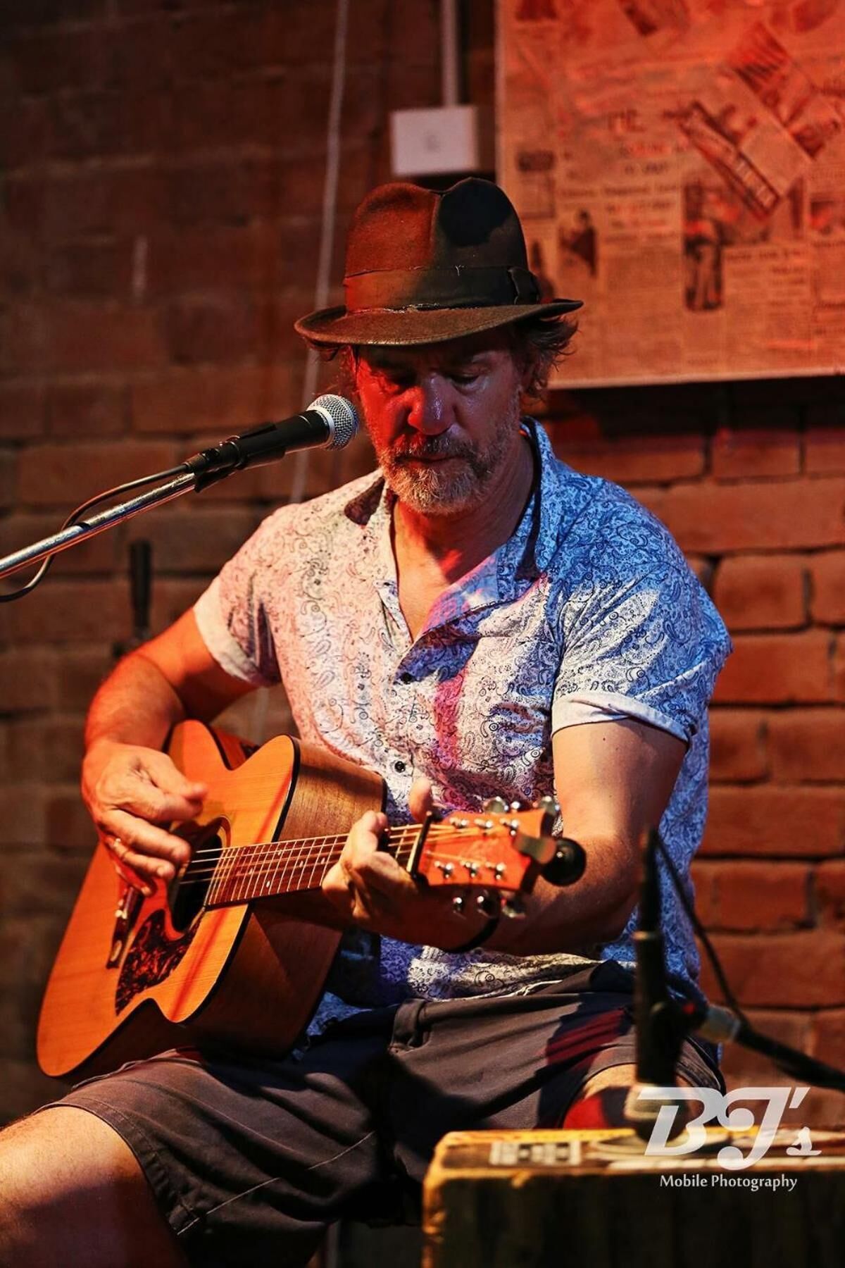 A person playing an acoustic guitar.