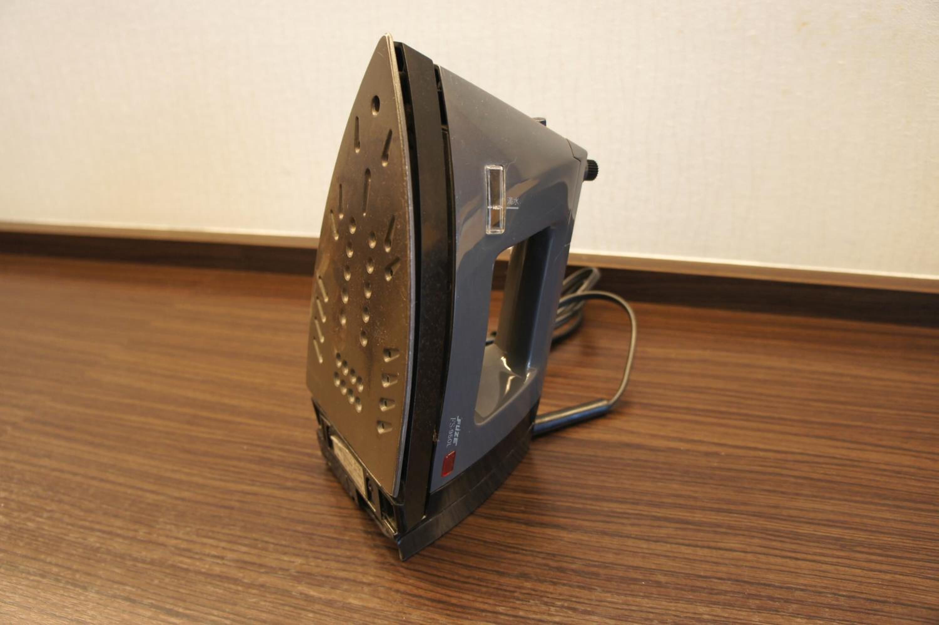 A portable iron on a wooden floor.