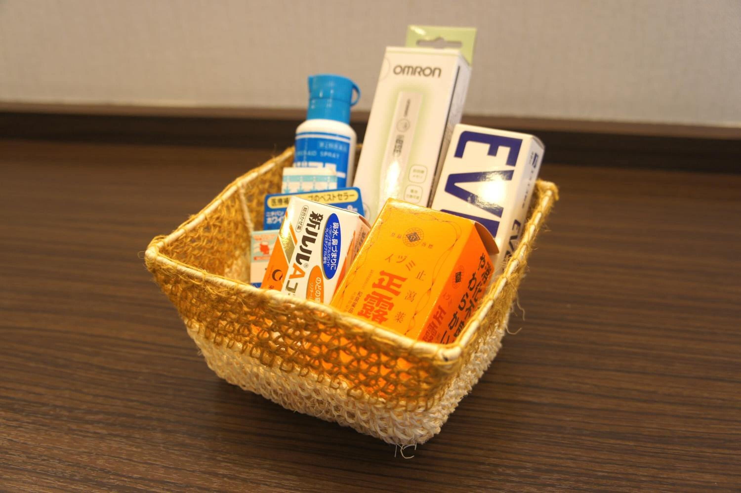 A woven basket containing various items on a wooden surface.