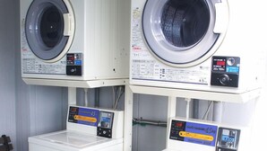 Two stacked washing machines with control panels and price tags. - Hotel Abest Kochi (Kochi)