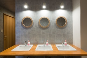 A restroom with three sinks, each with a mirror and soap dispenser. - 81's Inn Nakasu - Hostel (Fukuoka)