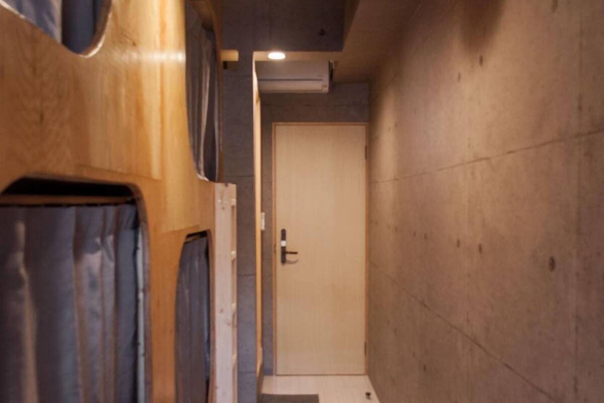 A narrow hallway with wooden walls and a door at the end.