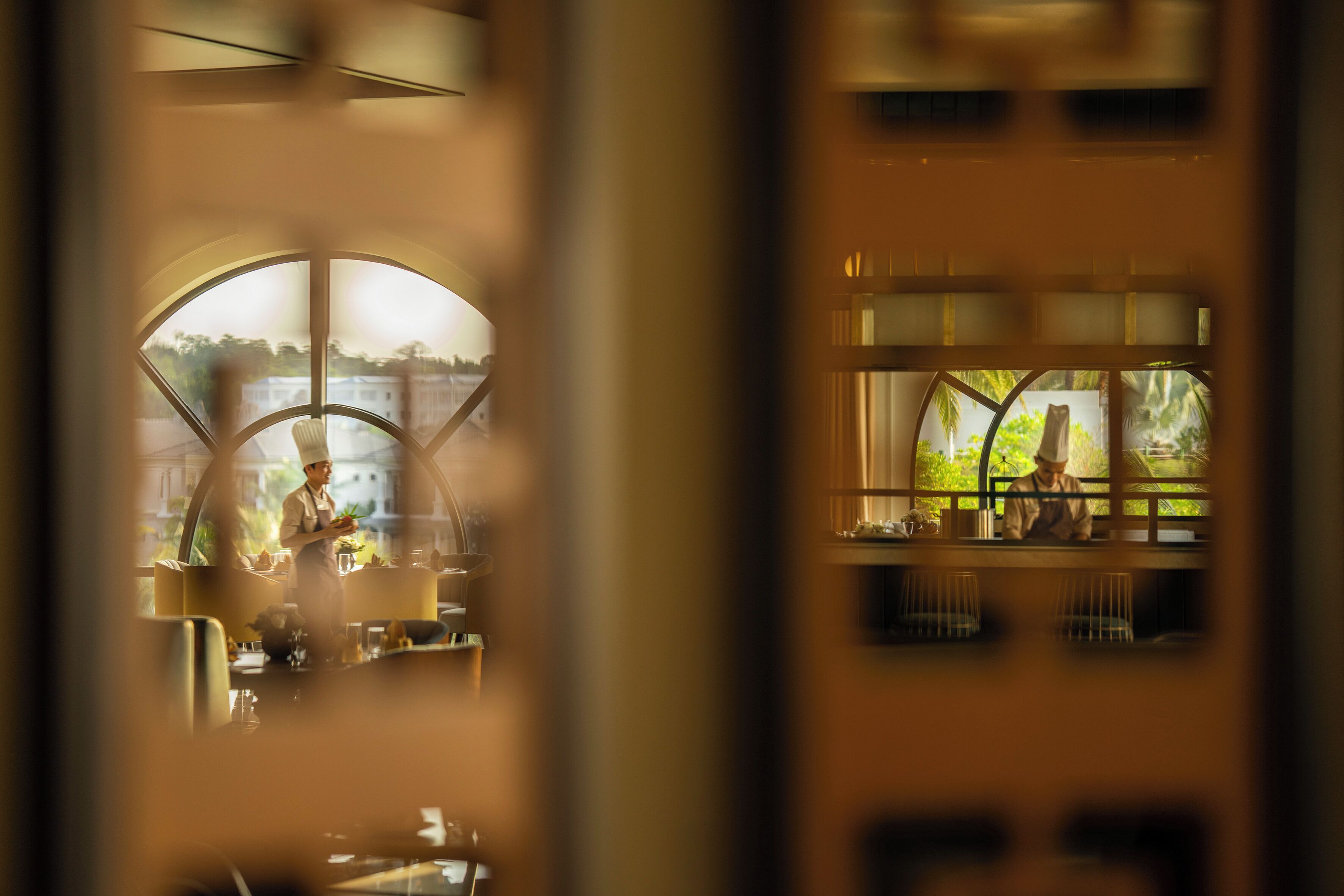 A restaurant with a view of a body of water and greenery.