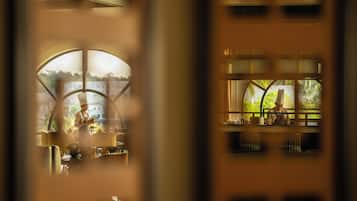 A restaurant with a view of a body of water and greenery.