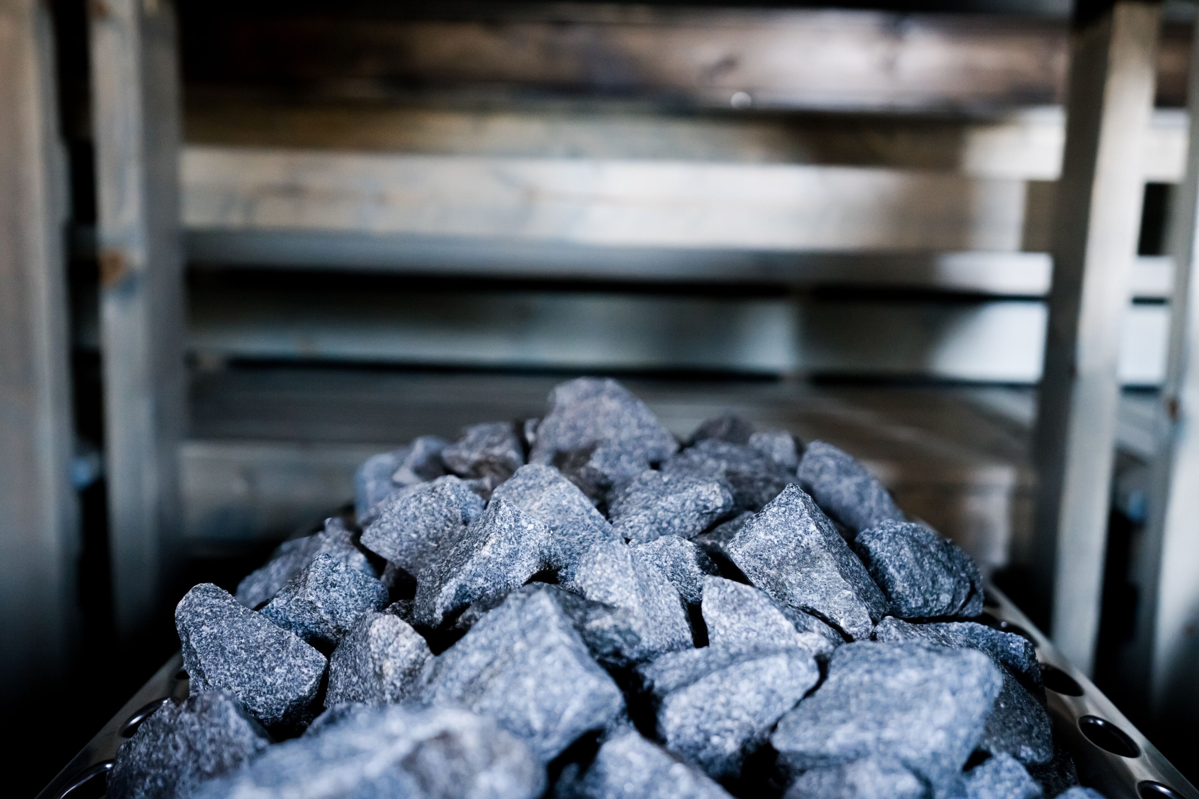 A close-up of charcoal briquettes in a metal container.