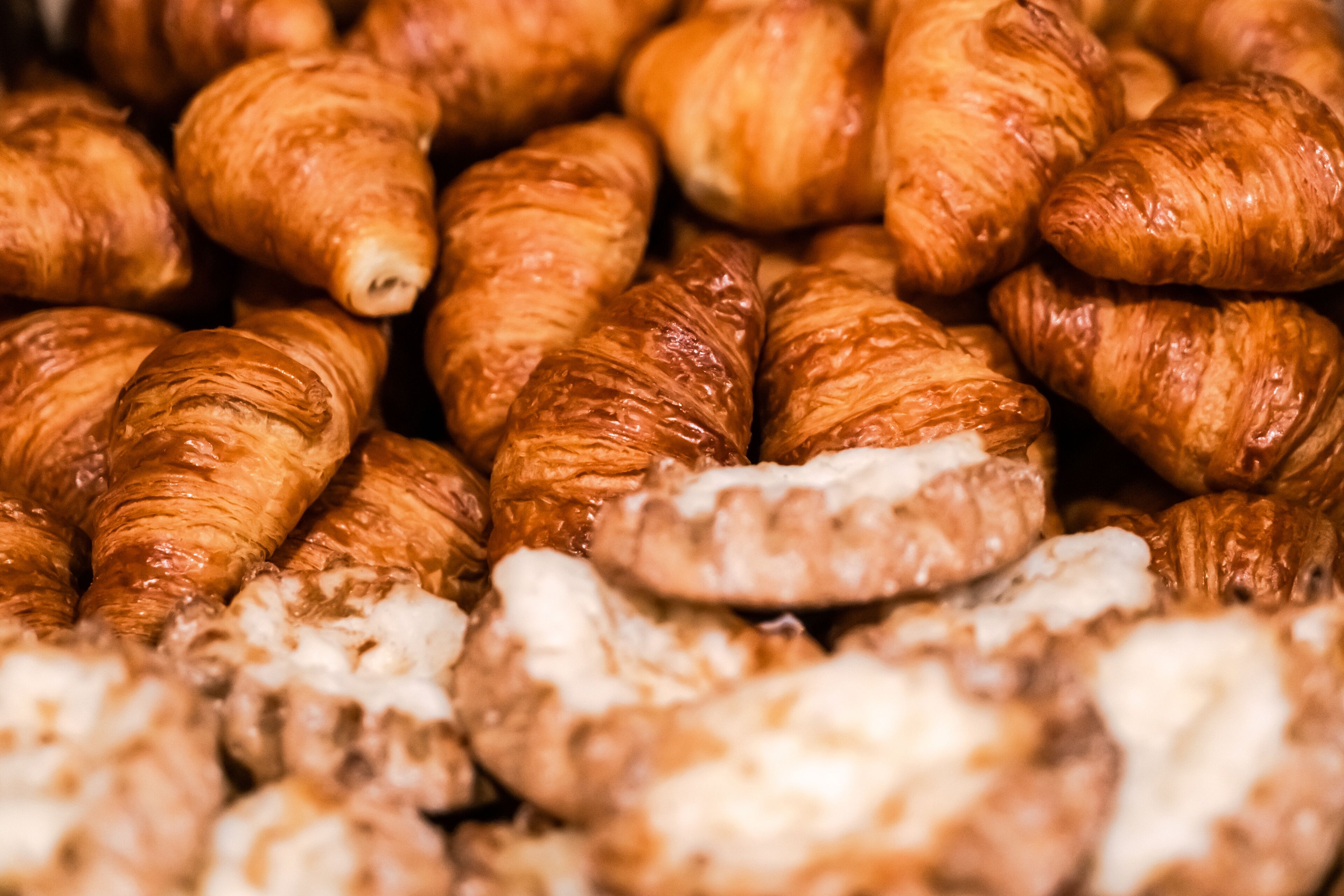 A close-up of various pastries, including croissants and other baked goods.