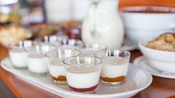 A tray with layered desserts on a wooden table.