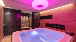 A modern spa room with a large hot tub, wooden walls, and a pink ambient light. - Hotel Ani (Makarska)