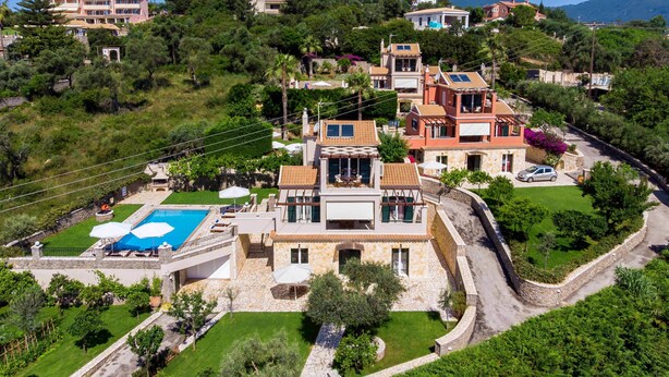 A hillside property with a swimming pool, stone walls, and multiple buildings. - Il Tesori Dassia Villas (Corfu)