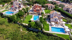 A residential area with multiple houses, a swimming pool, and a well-maintained garden. - Il Tesori Dassia Villas (Corfu)