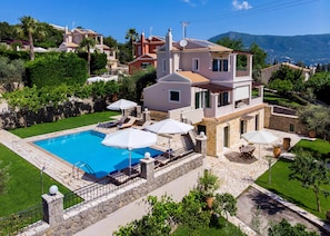 A two-story villa with a swimming pool, outdoor seating, and a stone pathway. - Il Tesori Dassia Villas (Corfu)
