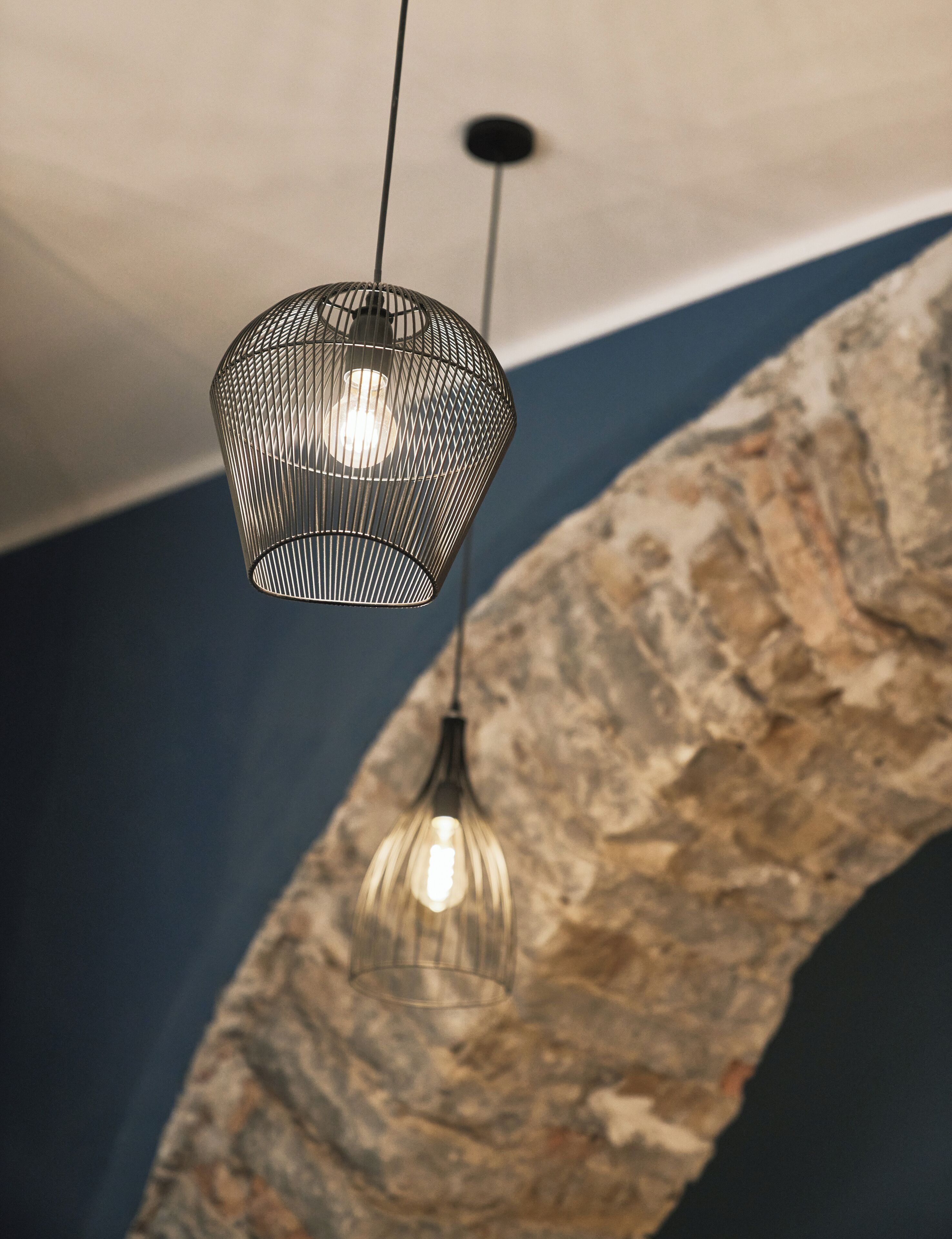 A hanging light fixture with a geometric design and a clear glass shade.