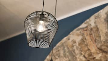 A hanging light fixture with a geometric design and a clear glass shade.